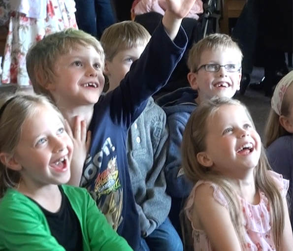 Audience watching a children's entertainer in Matlock and laughing