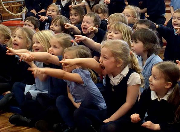 Schoolchildren watching children's entertainer Rotherham
